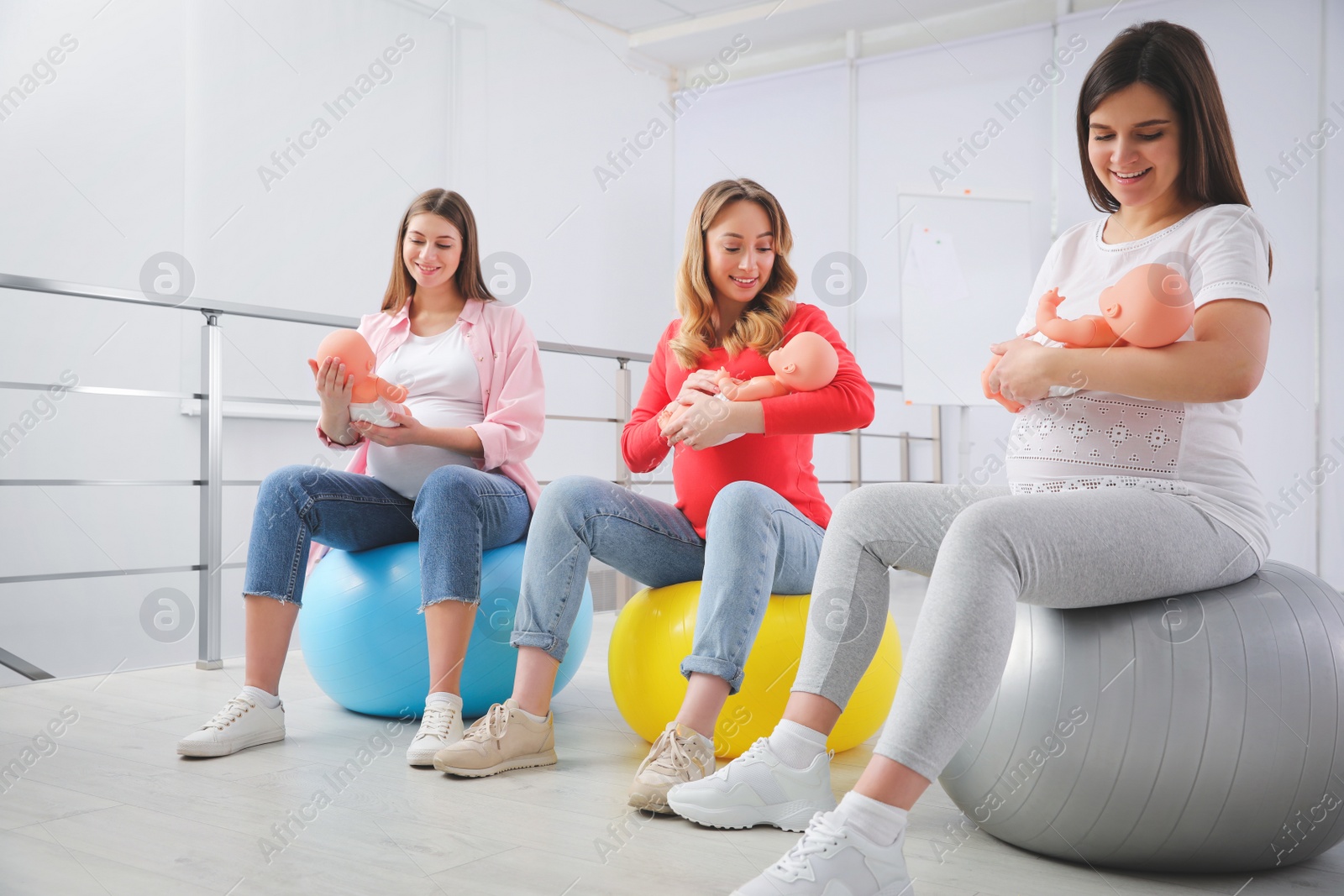 Photo of Group of pregnant women at courses for expectant mothers indoors