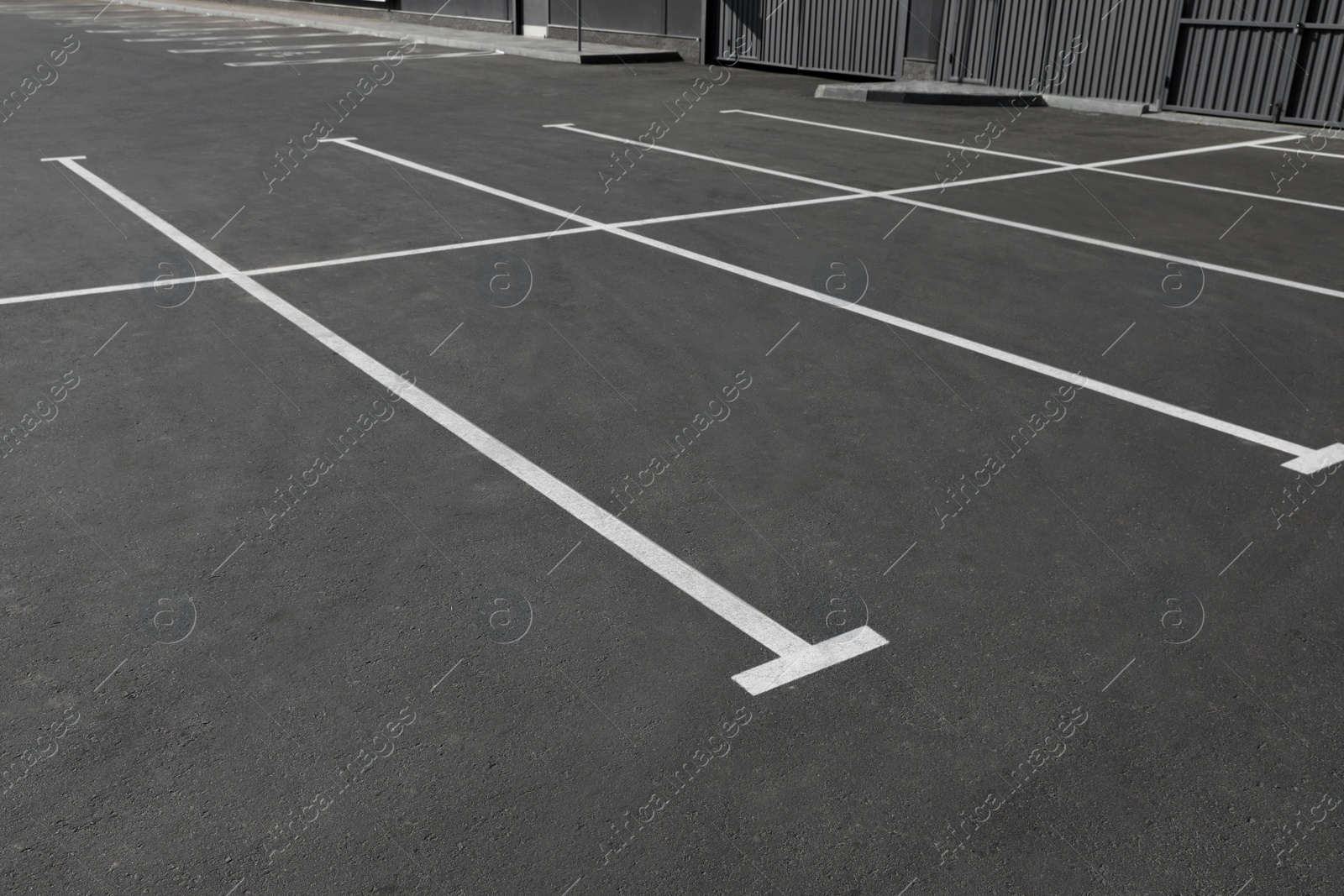 Photo of Car parking lot with white marking outdoors