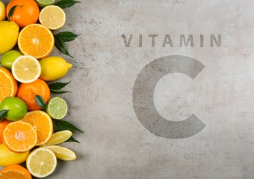 Image of Source of Vitamin C. Flat lay composition with tangerines and different citrus fruits on grey background
