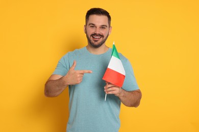 Man with flag of Italy on yellow background