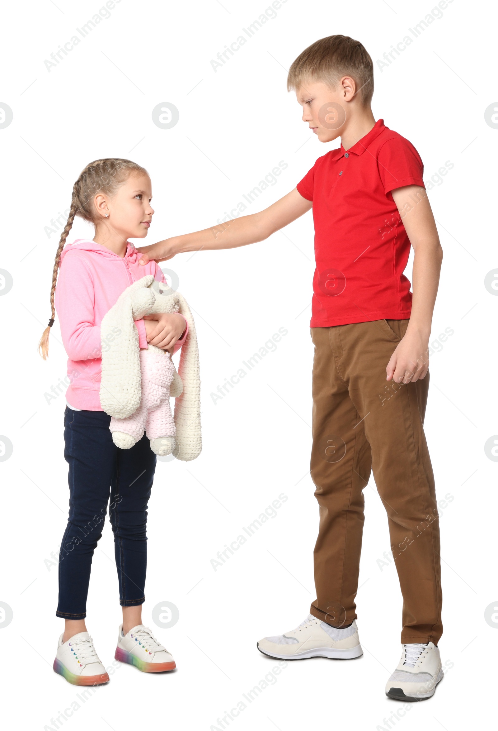 Photo of Boy bullying upset kid on white background