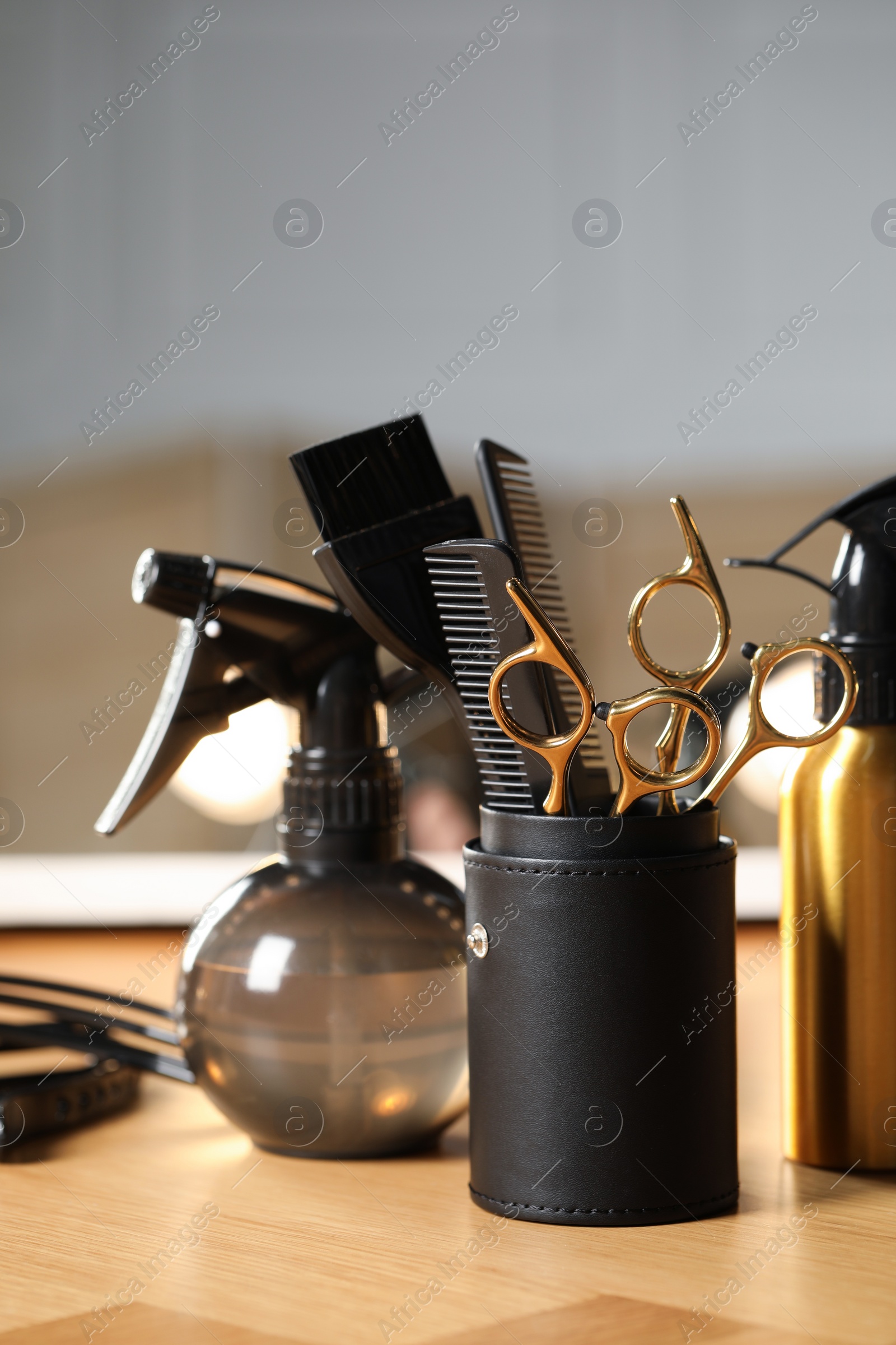 Photo of Set of hairdresser tools on table in salon