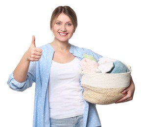 Photo of Happy woman with basket full of laundry showing thumb up on white background