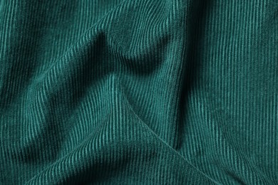 Photo of Texture of dark green crumpled fabric as background, top view