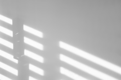 Image of Light and shadows falling on white wall