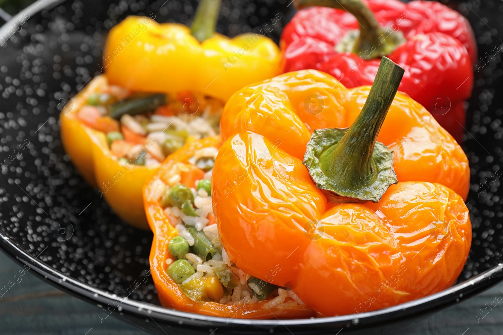 Photo of Tasty stuffed bell peppers in baking dish, closeup