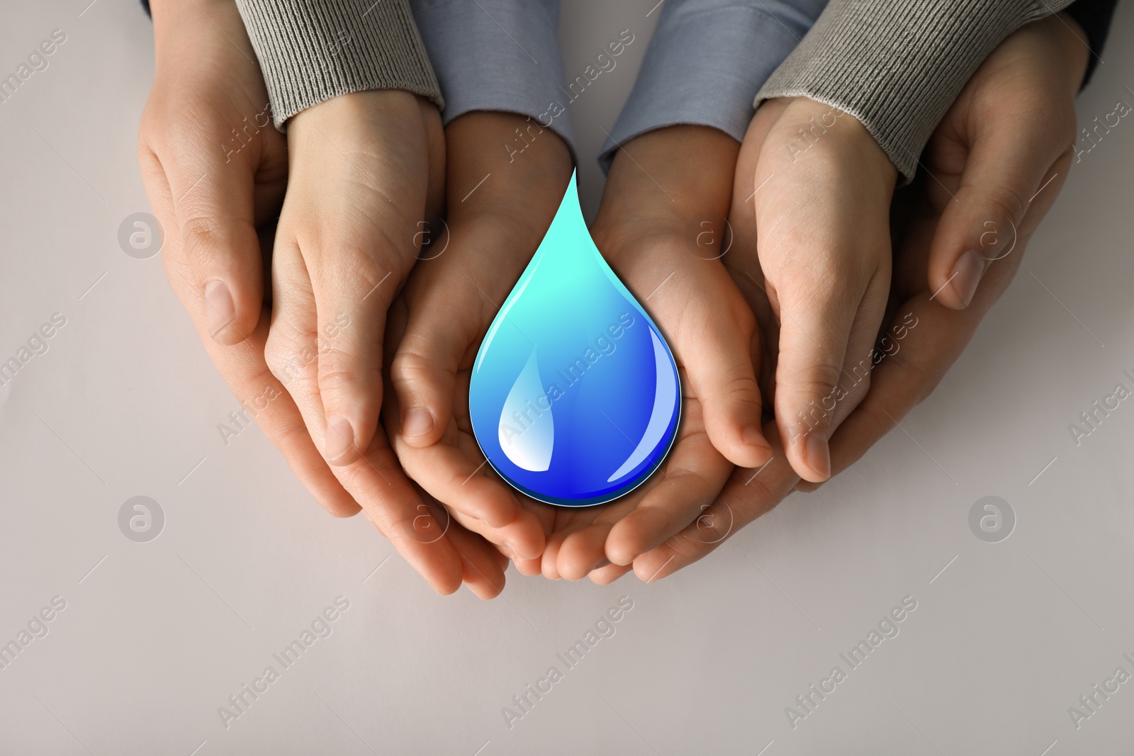 Image of Family holding paper water drop on light grey background, top view