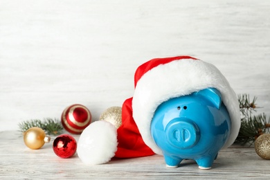 Composition with piggy bank and Christmas decor on table. Space for text