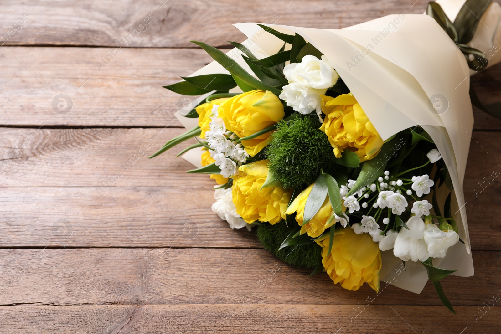 Photo of Beautiful bouquet with peony tulips on wooden table