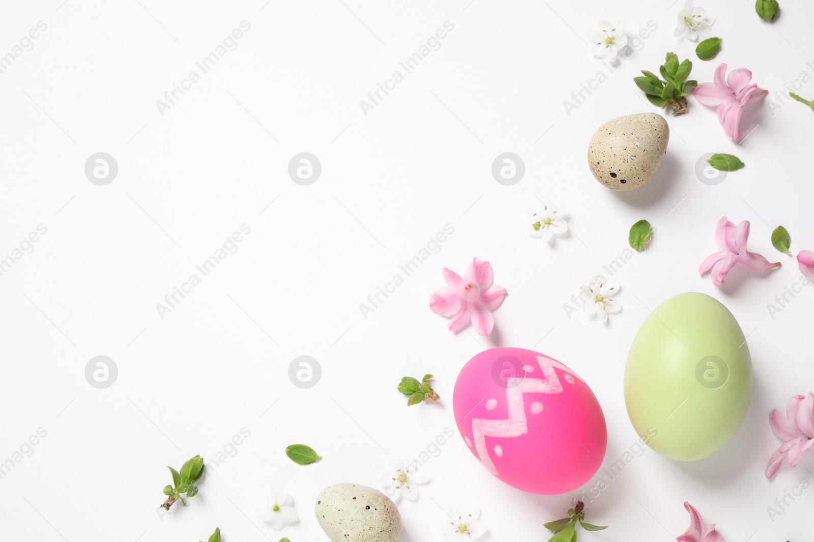 Photo of Flat lay composition with Easter eggs on white background. Space for text