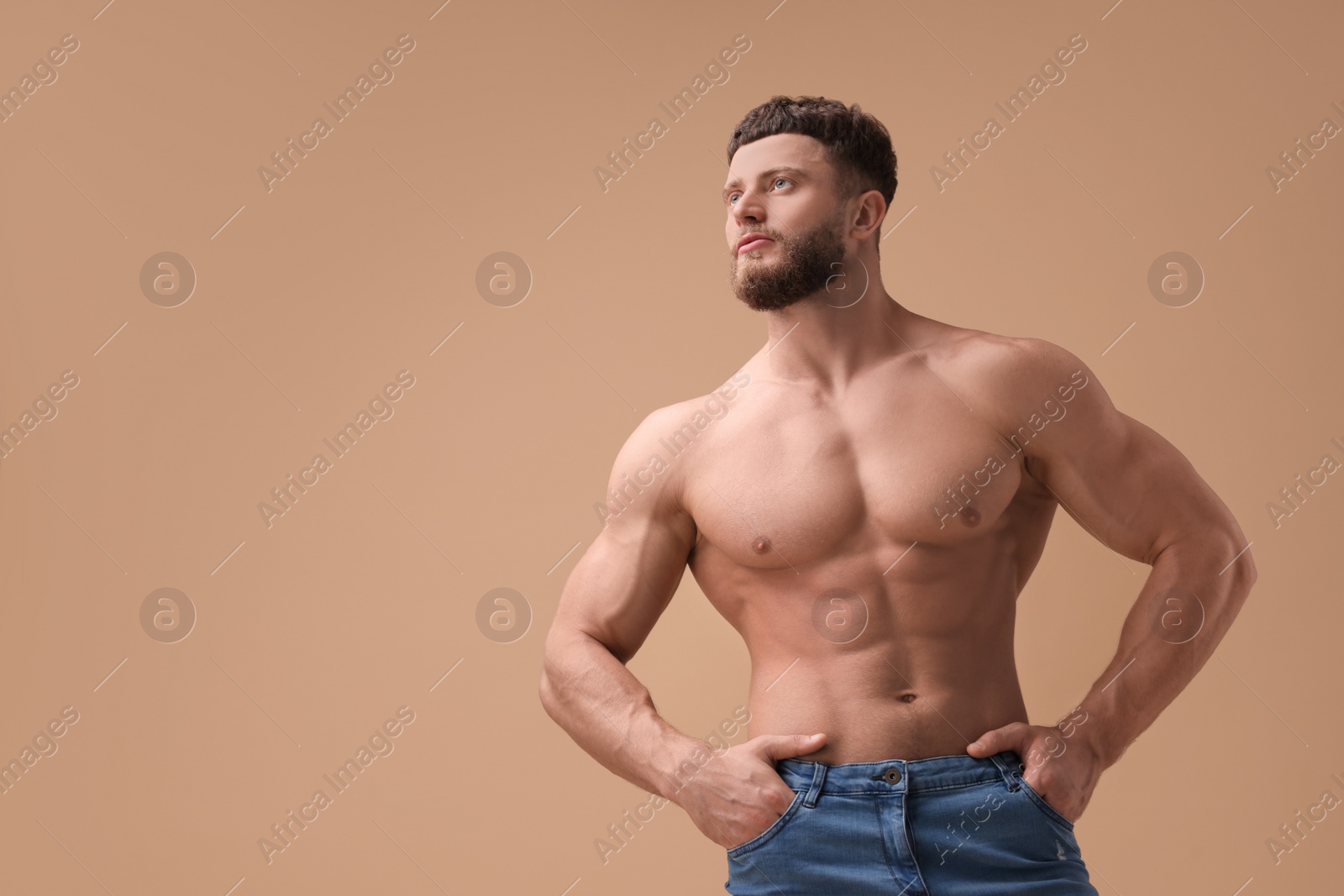 Photo of Handsome muscular man on beige background, space for text. Sexy body