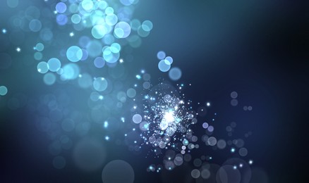 Image of Magic lights on blue gradient background, bokeh effect