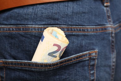 Photo of Euro banknotes in pocket of jeans, closeup. Spending money