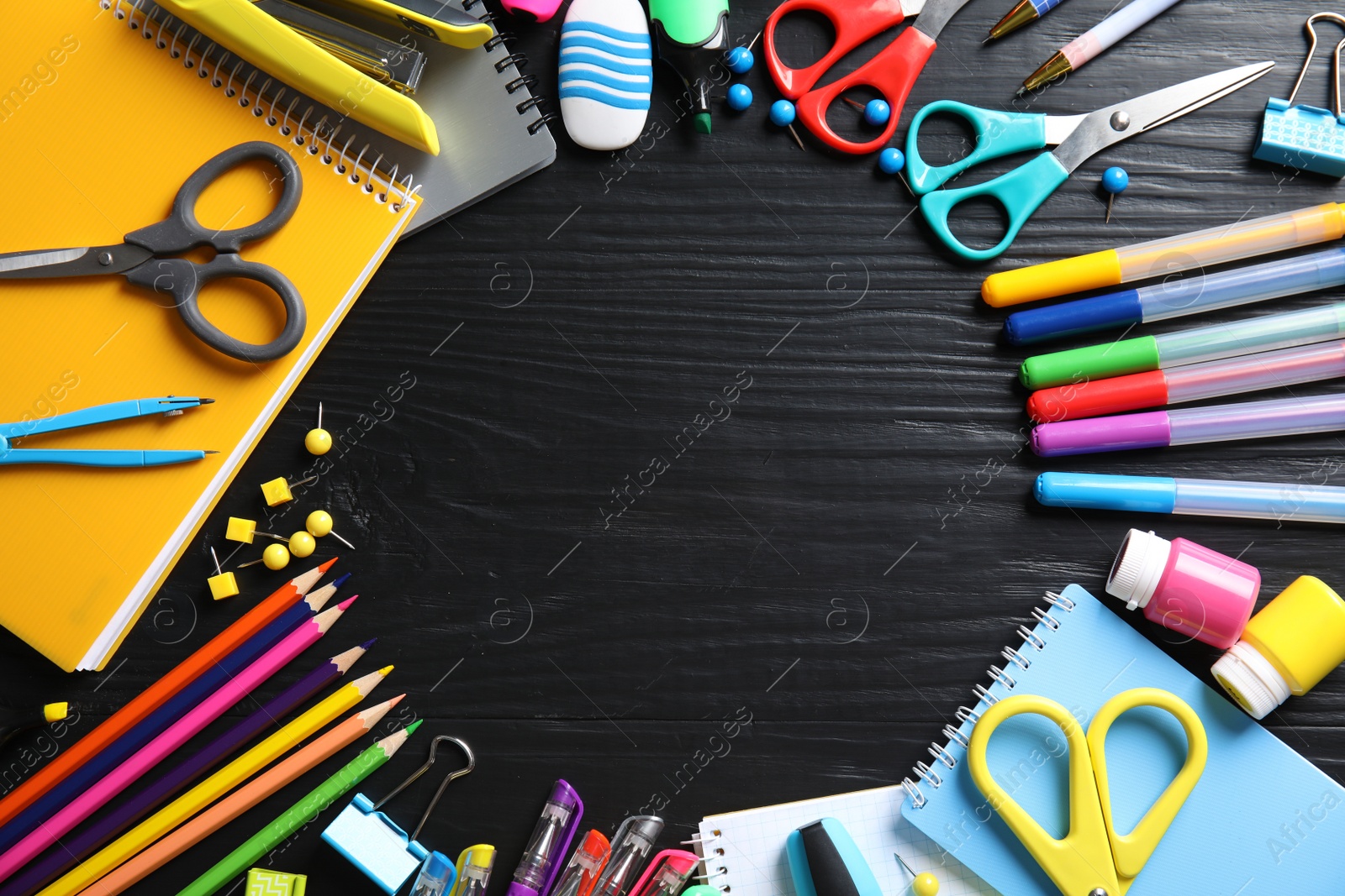 Photo of Different school stationery with space for design on wooden background, flat lay