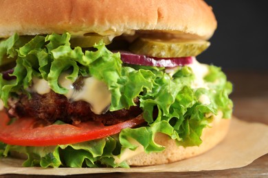 Delicious burger with beef patty and lettuce on table, closeup