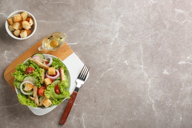 Photo of Delicious fresh chicken salad served on grey table, flat lay. Space for text