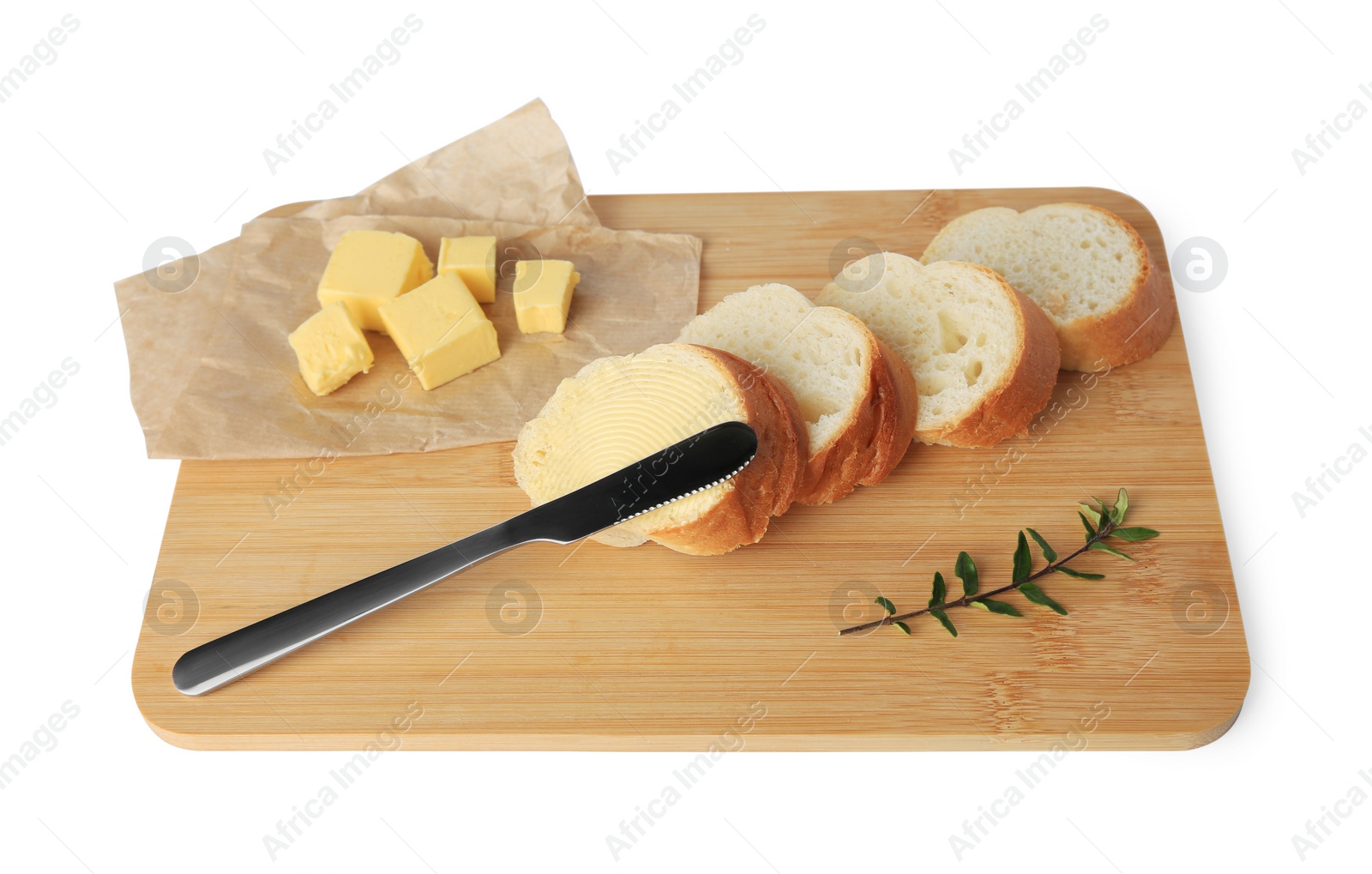 Photo of Wooden board with sliced baguette and fresh butter on white background