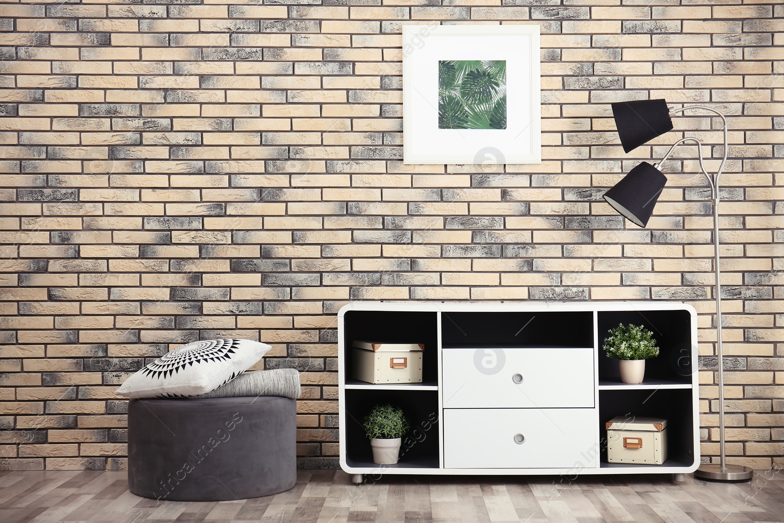 Photo of Elegant room interior with stylish shelving unit and ottoman