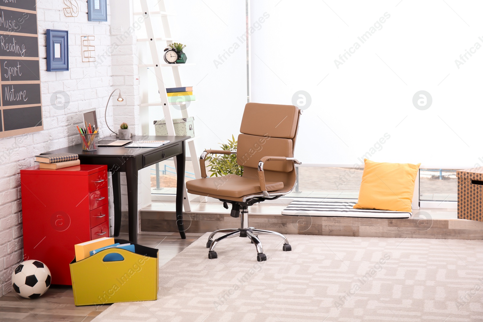 Photo of Modern child room interior with desk and laptop