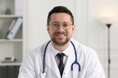 Portrait of smiling doctor with stethoscope indoors