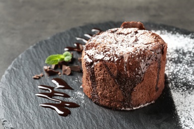 Delicious fresh fondant with hot chocolate served on slate plate. Lava cake recipe