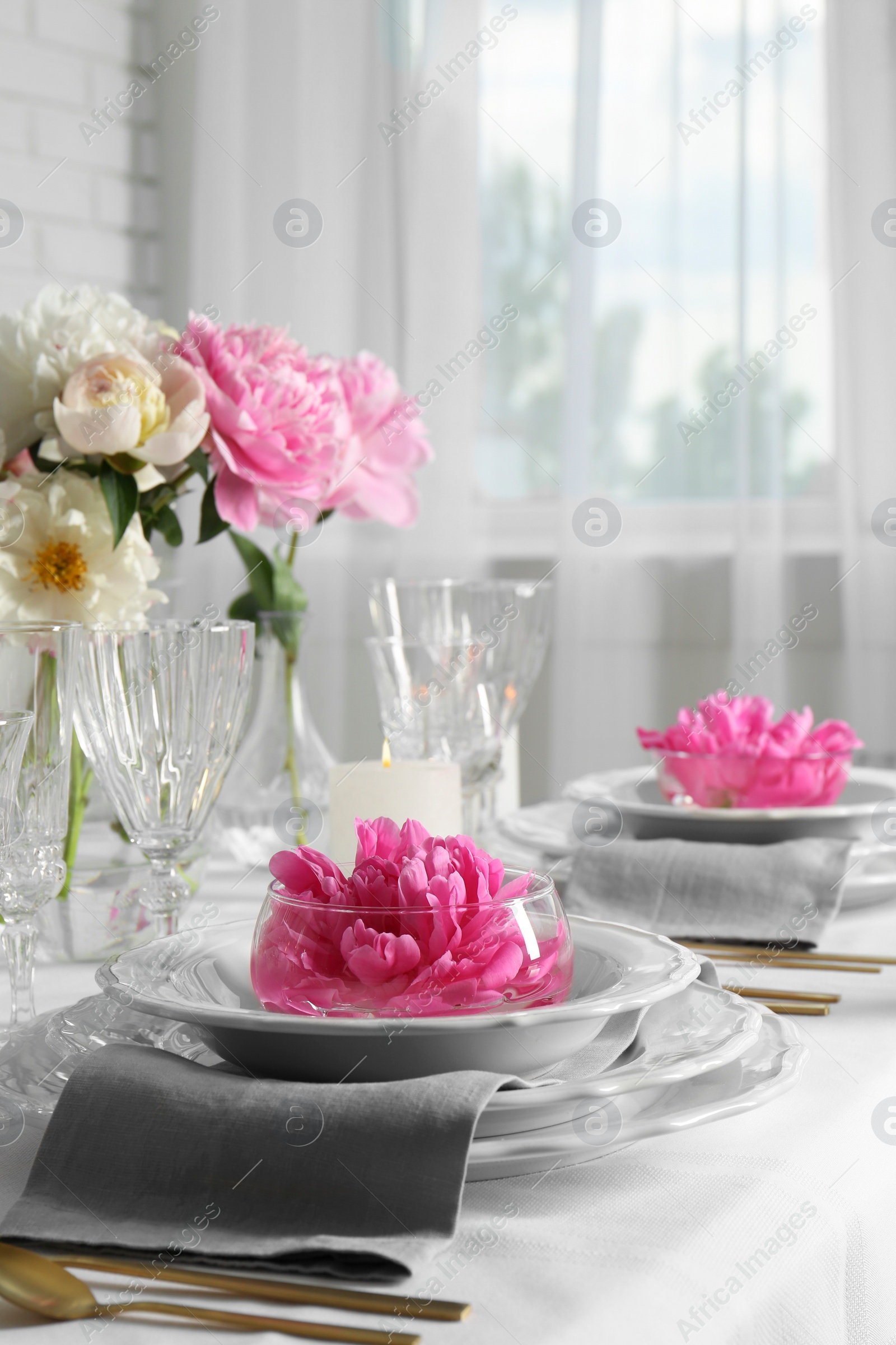 Photo of Stylish table setting with beautiful peonies in dining room