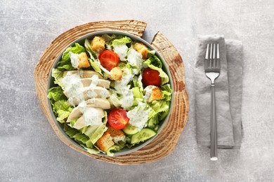 Photo of Delicious salad with Chinese cabbage, cucumber, meat and tomatoes served on grey table, flat lay