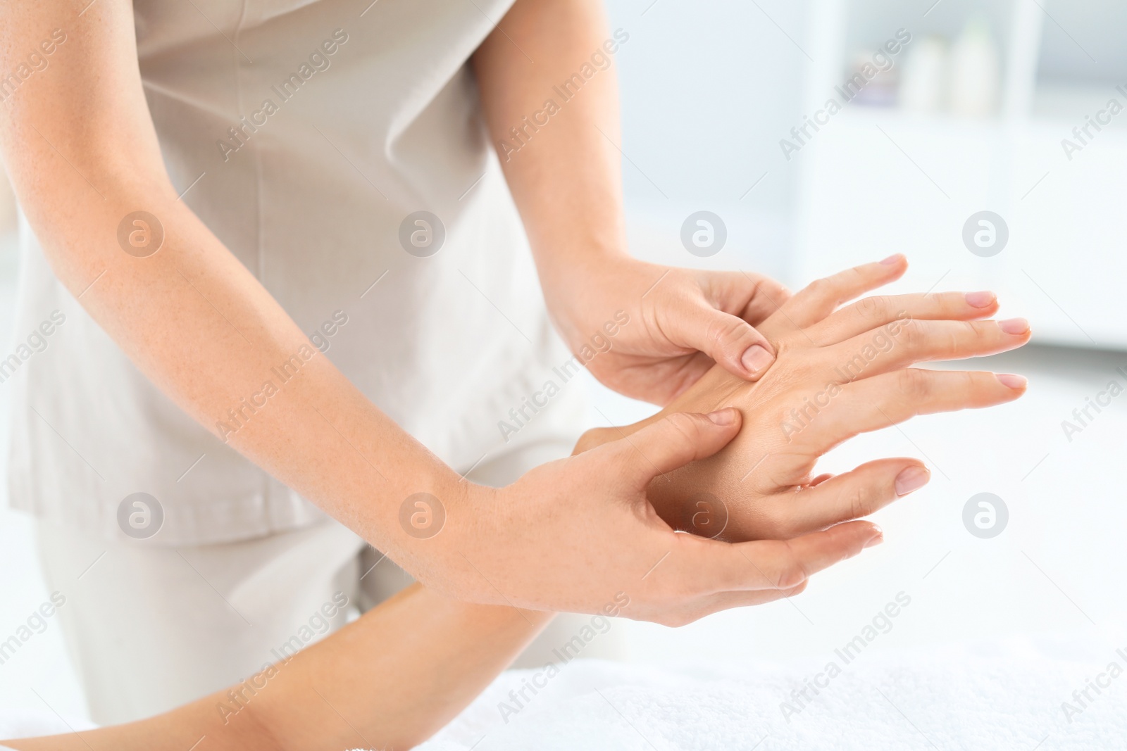 Photo of Woman receiving hand massage in wellness center, closeup