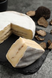 Delicious truffle cheese on grey table, closeup