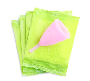 Photo of Menstrual pads and cup on white background, top view. Gynecological care