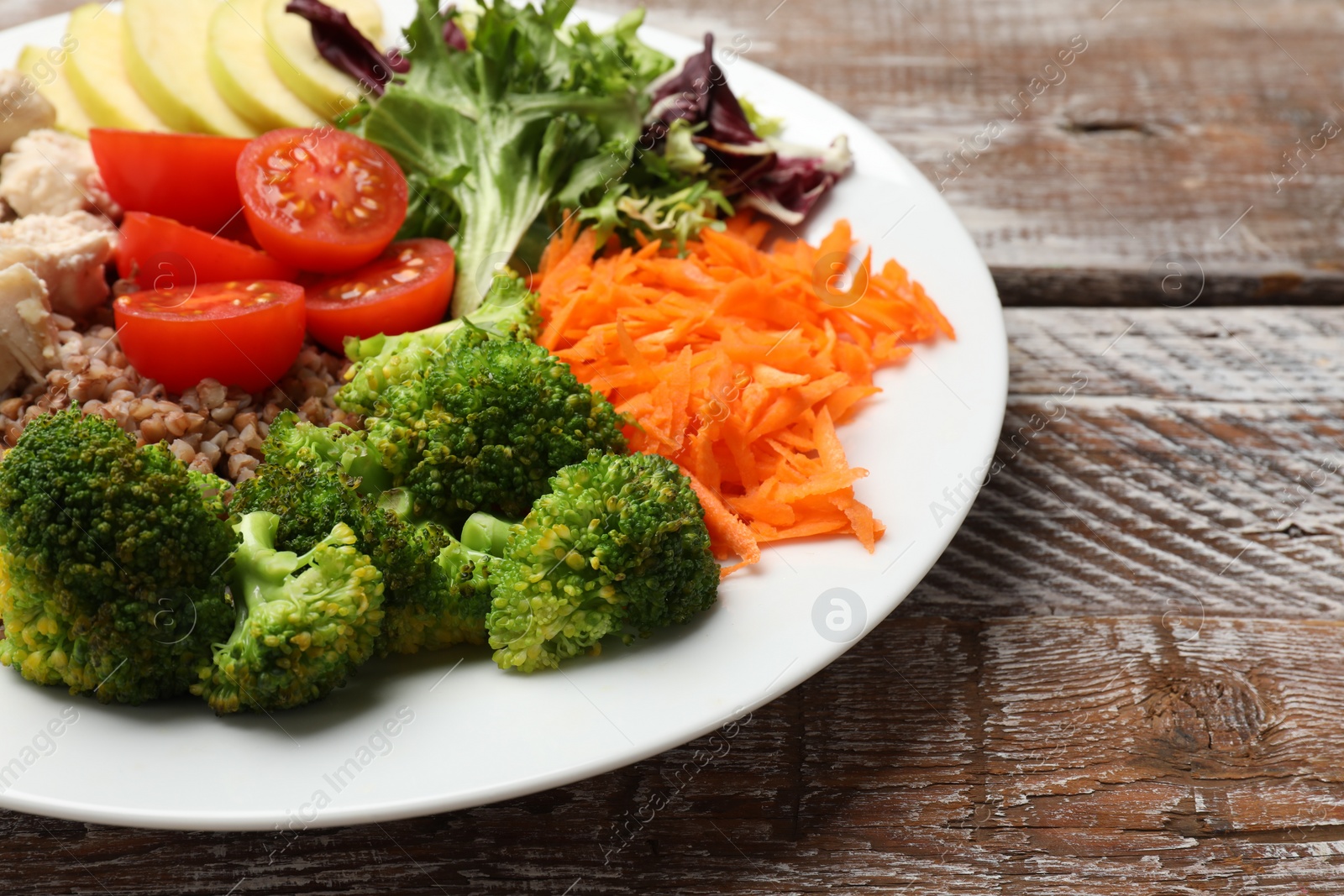 Photo of Balanced diet and healthy foods. Plate with different delicious products on wooden table, closeup