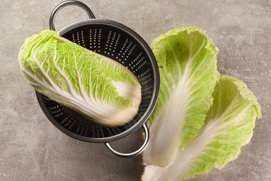 Photo of Fresh ripe Chinese cabbage and leaves on light grey table, flat lay