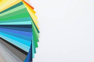 Photo of Color palette samples on white background top view