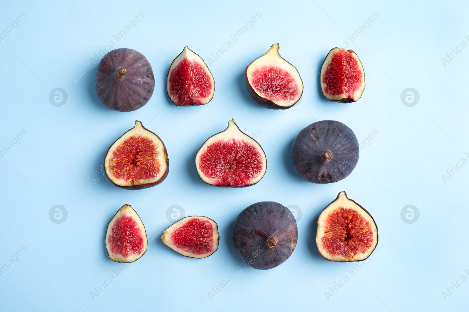 Photo of Delicious ripe figs on light blue background, flat lay