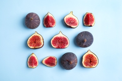 Photo of Delicious ripe figs on light blue background, flat lay