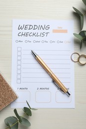 Photo of Flat lay composition with Wedding Checklist and planner on white wooden table