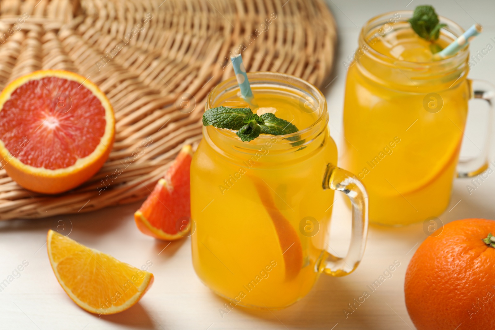 Photo of Delicious orange soda water on white wooden table