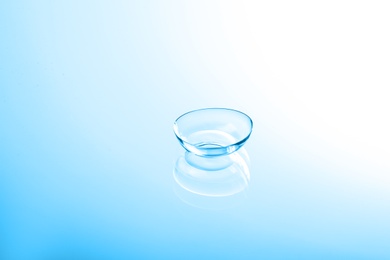 Photo of Contact lens on color glass background