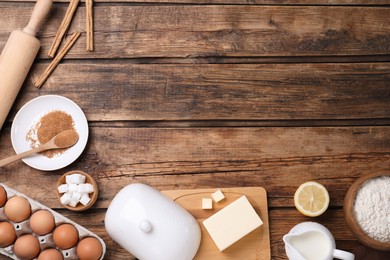 Cooking utensils and ingredients on wooden table, flat lay. Space for text