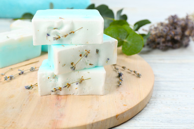 Photo of Natural handmade soap bars on white wooden table