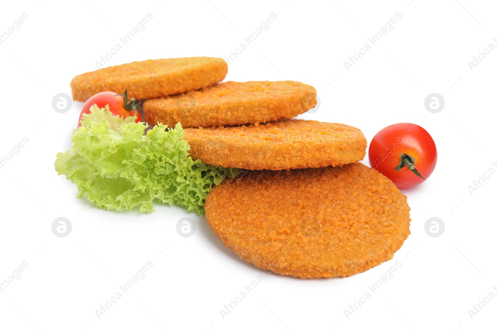 Photo of Uncooked breaded cutlets, tomatoes and lettuce on white background. Freshly frozen semi-finished product