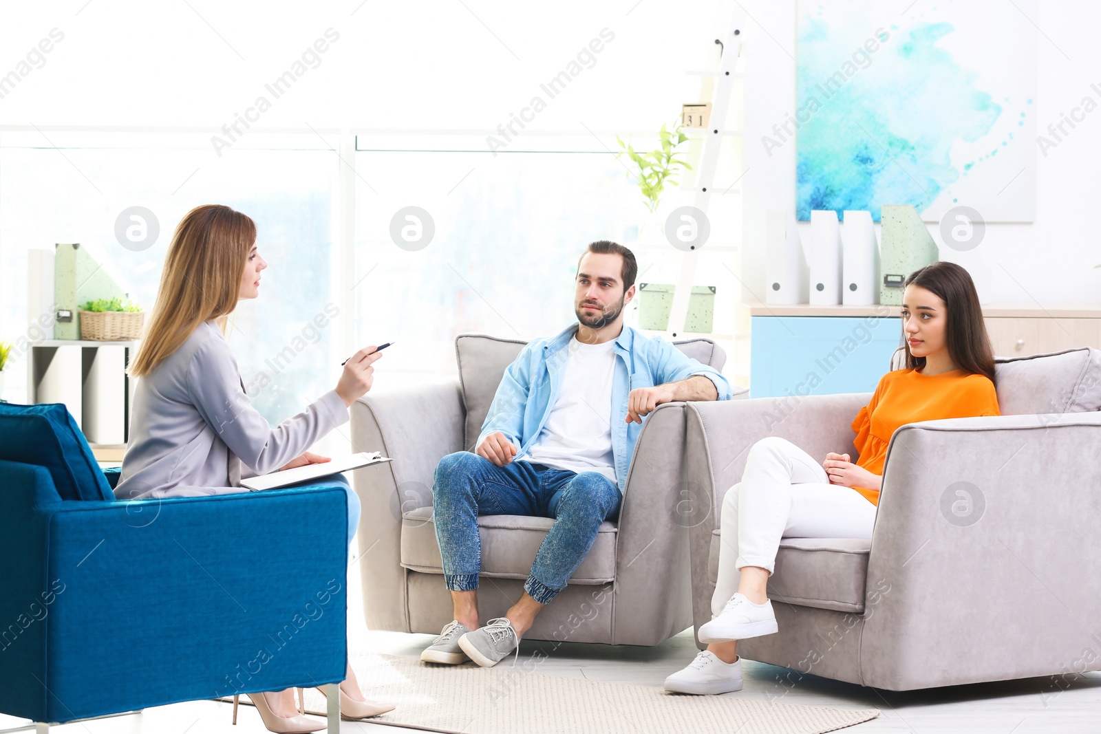 Photo of Family psychologist working with young couple in office