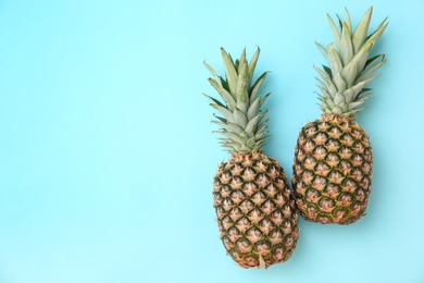 Photo of Fresh pineapples on color background