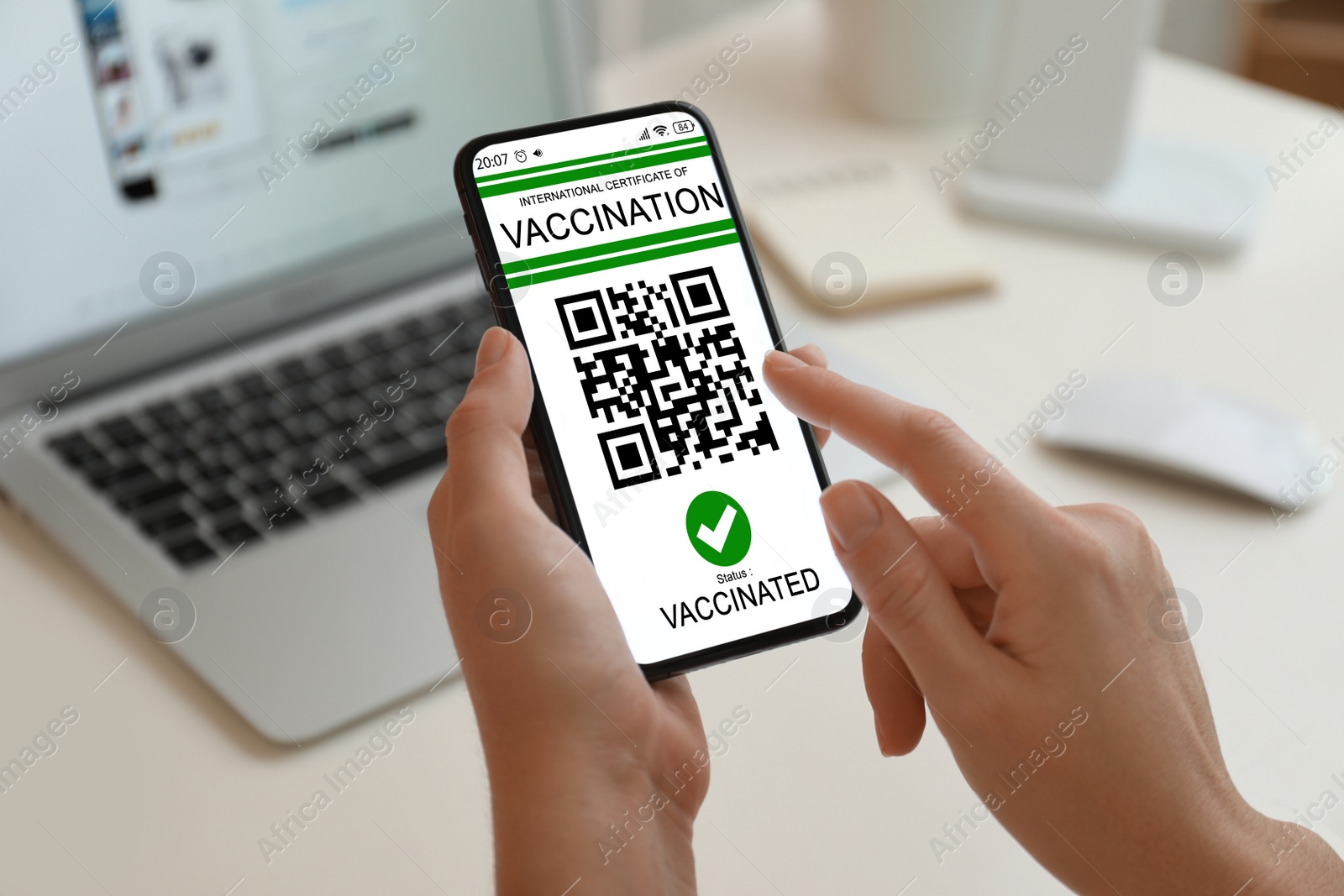 Image of Woman holding smartphone with international certificate of vaccination indoors, closeup