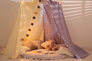 Photo of Modern children's room interior with play tent