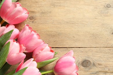 Photo of Happy Mother's Day. Beautiful pink tulips on wooden table, flat lay. Space for text