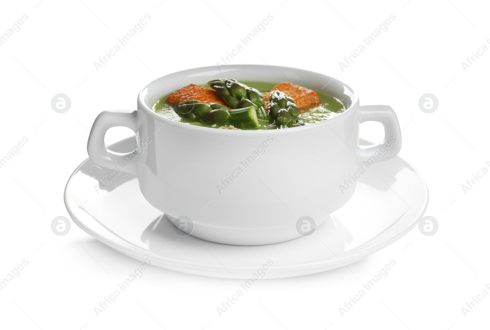 Photo of Delicious asparagus soup with rusks isolated on white