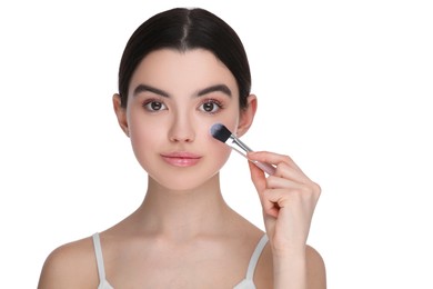 Teenage girl with makeup brush on white background