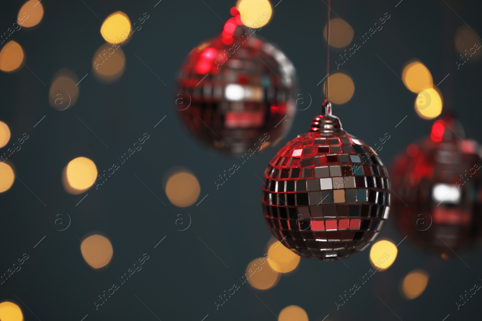 Photo of Shiny disco balls against blurred lights, space for text