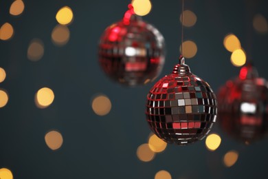 Photo of Shiny disco balls against blurred lights, space for text